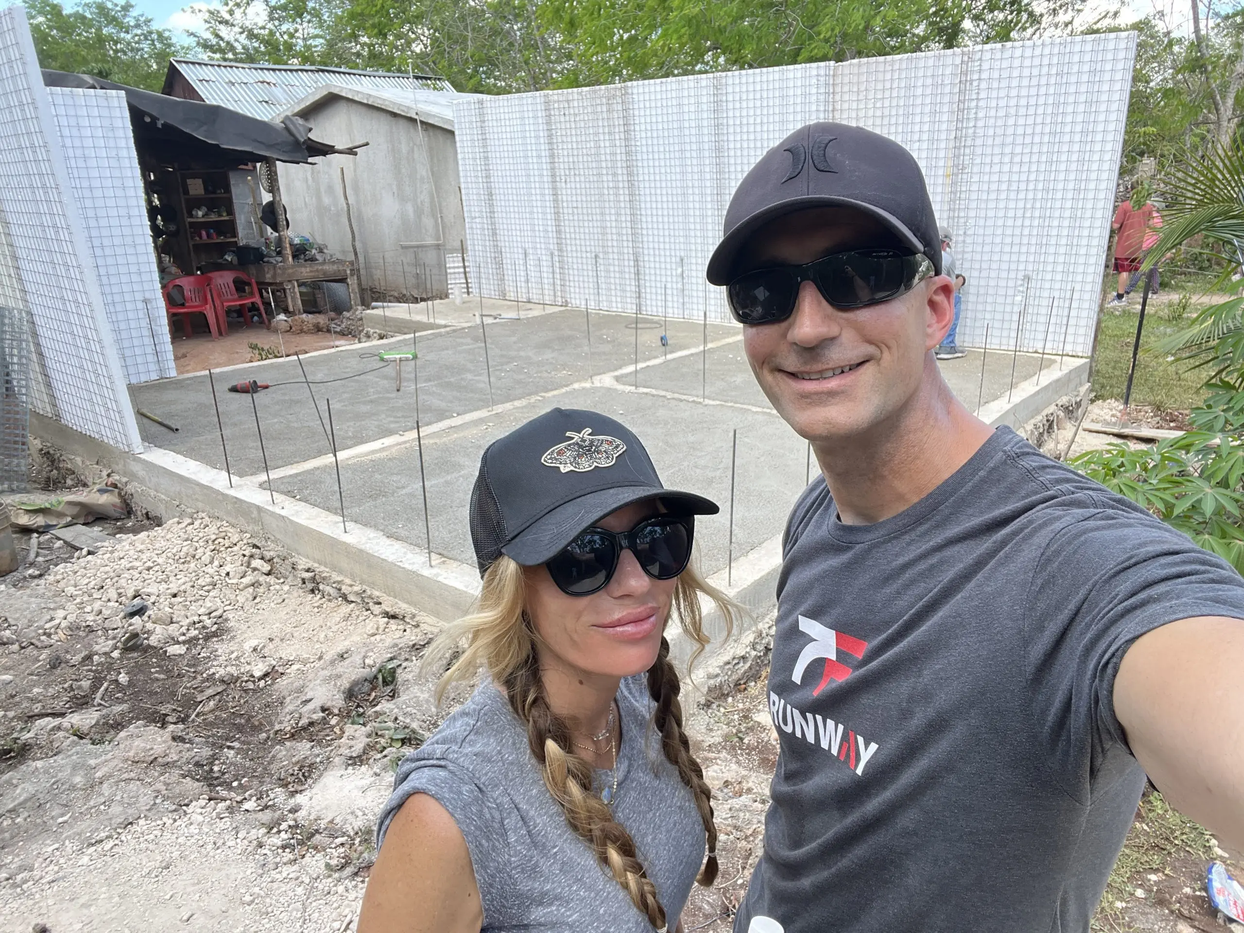 BlueSky Home Offer owners visiting an active construction site with concrete foundation and foam block walls.
